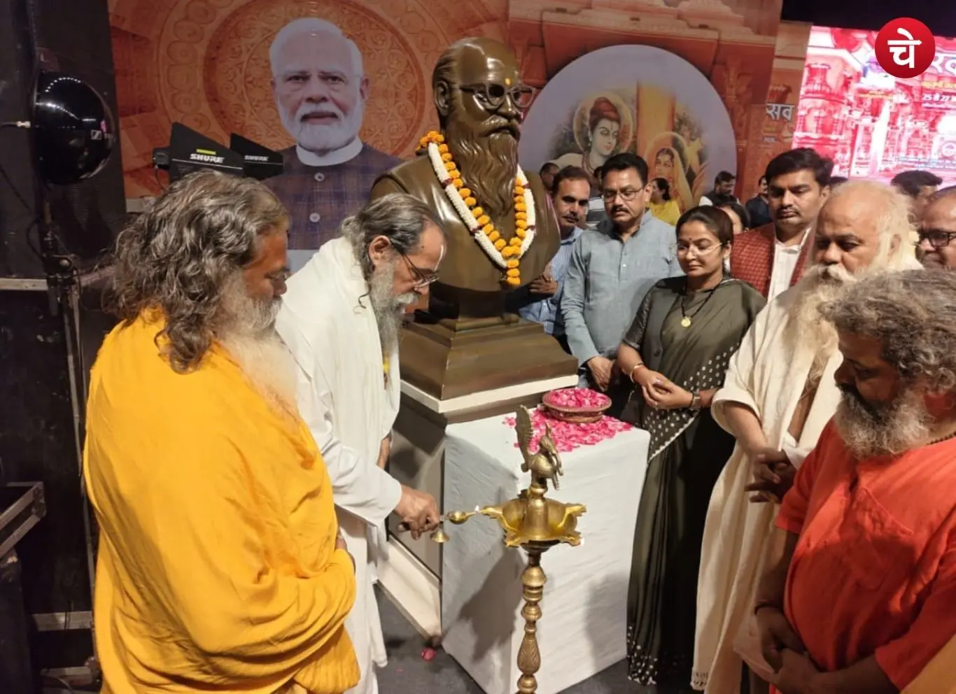 A guest paying floral tributes at the statue of Nanaji Deshmukh